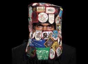 Photo Credit: Tony Albert and Vincent Namatjira, Australia’s Most Wanted Armed with a Paintbrush, 2018, archival pigment print on paper, found patches, fabric, 100 x 100 cm.Courtesy of the artist and Sullivan + Strumpf, Sydney and Singapore