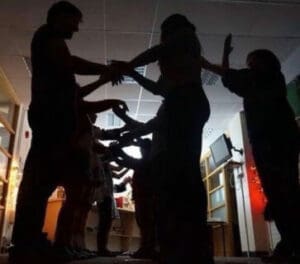 Sillhouettes of people dancing in a room